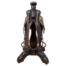 Load image into Gallery viewer, The Chaps Saddle Barstool features full-grain leather, embossed Western patterns, copper conchos, and a 180° swivel wooden base. A handcrafted Western saddle barstool that celebrates cowboy craftsmanship and the artistry of the American frontier.