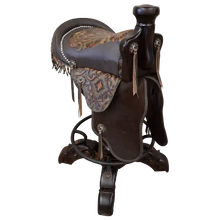 Load image into Gallery viewer, The Chaps Saddle Barstool features full-grain leather, embossed Western patterns, copper conchos, and a 180° swivel wooden base. A handcrafted Western saddle barstool that celebrates cowboy craftsmanship and the artistry of the American frontier.