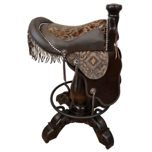 Load image into Gallery viewer, The Chaps Saddle Barstool features full-grain leather, embossed Western patterns, copper conchos, and a 180° swivel wooden base. A handcrafted Western saddle barstool that celebrates cowboy craftsmanship and the artistry of the American frontier.