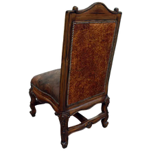 Load image into Gallery viewer, The Matador Dining Chair combines embossed full-grain leather, hand-carved hardwood, and Spanish Colonial artistry. A luxurious Western dining chair handcrafted for beauty, comfort, and endurance. Fully customizable and guaranteed for life.