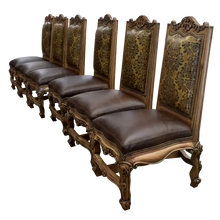 Load image into Gallery viewer, The Picador Dining Chair features full-grain leather upholstery, embossed floral detailing, and hand-carved hardwood. A Spanish Colonial-inspired dining chair blending Western luxury with artisanal craftsmanship. 100% customizable and guaranteed for life.