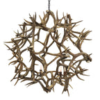 Antler chandelier with three light bulbs on a gray background