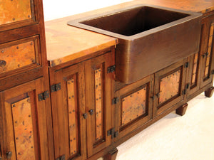 Upgrade your kitchen with a handcrafted copper sink and rustic storage cabinets. Featuring hammered copper, wood cabinetry, and iron details, this design combines beauty and function.