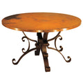 Round metal table with decorative legs on a white background