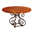 Round wooden table with decorative metal base on a white background