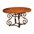 Round wooden table with decorative metal base on a white background