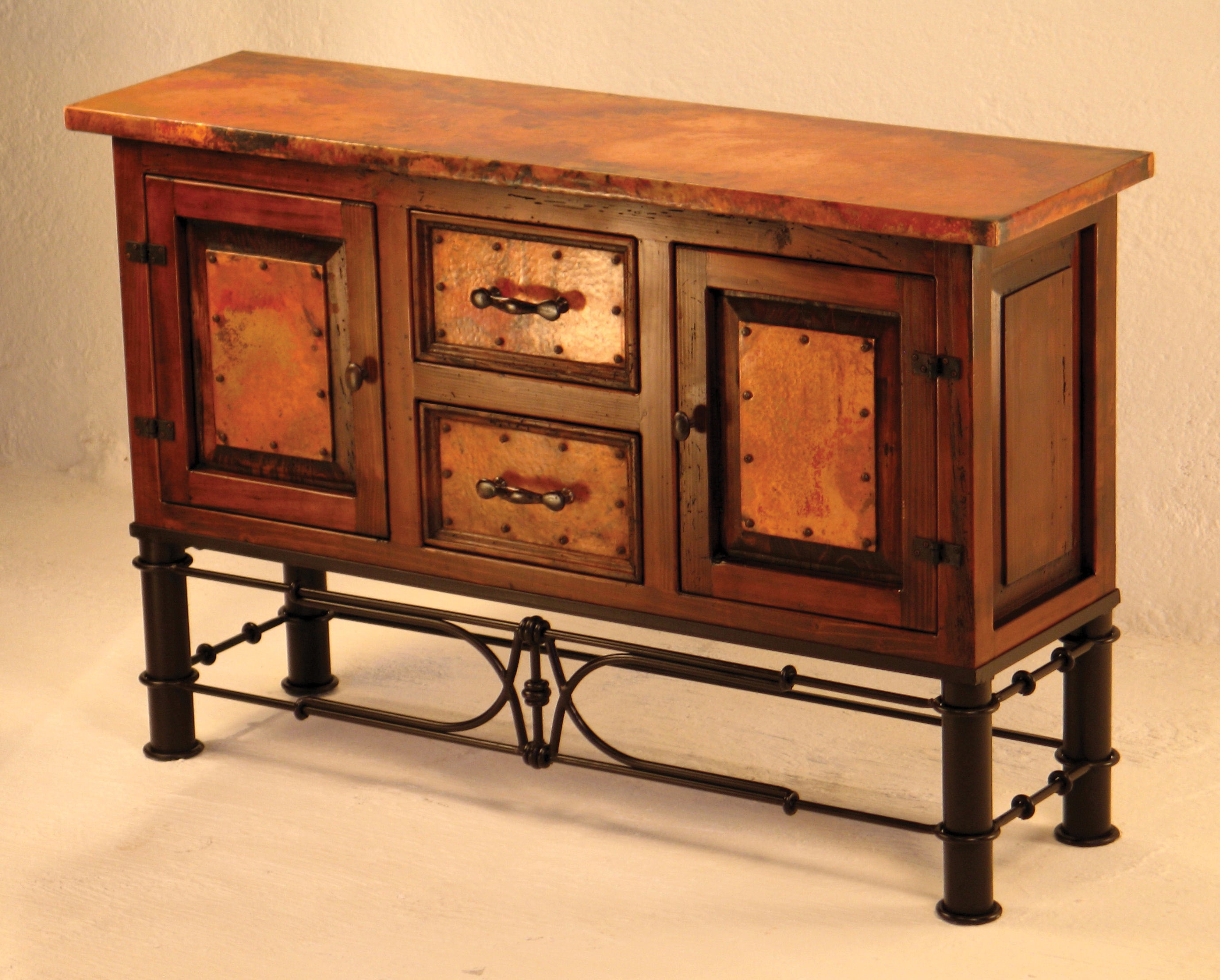 Shop the 2-Door / 2-Drawer Copper Console with Pablo Base – handcrafted with hammered copper panels, a solid wood frame, and a forged iron base. Perfect rustic storage for your home.