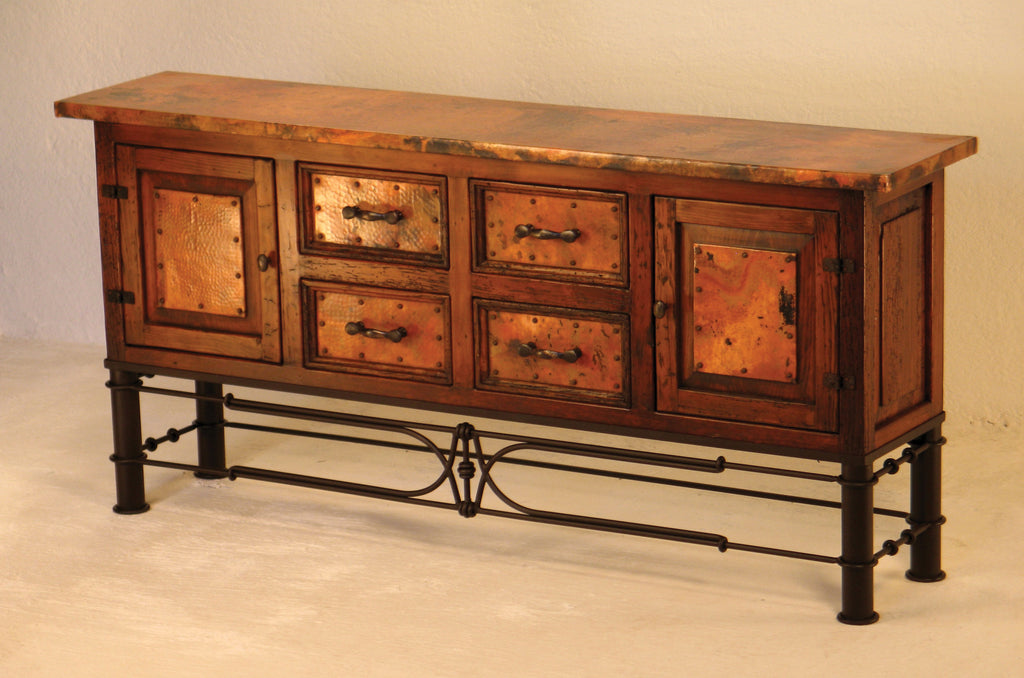 Add rustic elegance to your home with the 2-Door/4-Drawer Copper Console w/ Pablo Base. Featuring handcrafted copper panels, solid wood, and wrought iron detailing, this versatile storage piece is perfect for entryways, dining rooms, or living spaces.