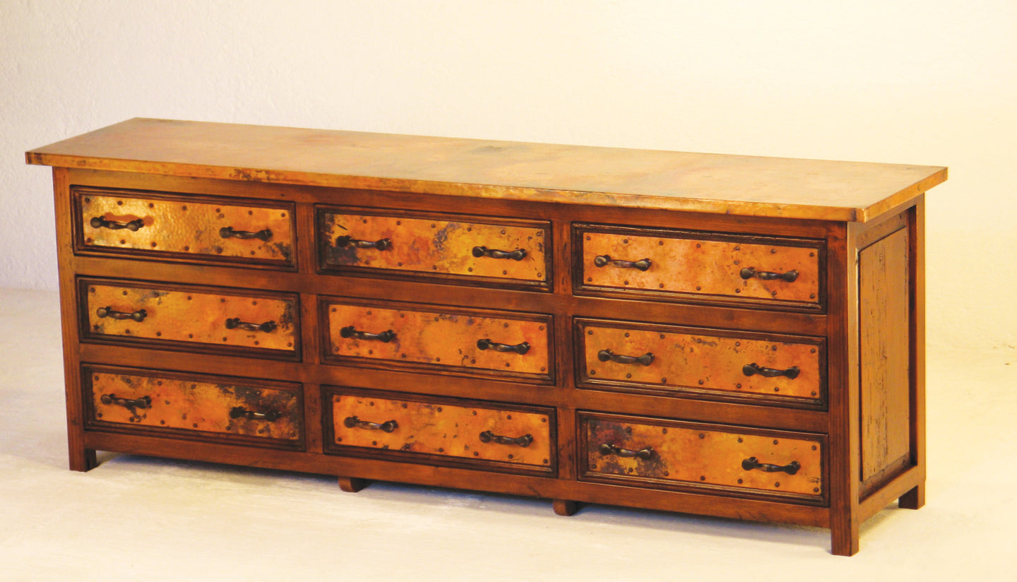 Add warmth and storage with the 9-Drawer Lowboy Copper Dresser. Features hand-hammered copper panels, solid wood frame, and forged metal hardware for rustic elegance.