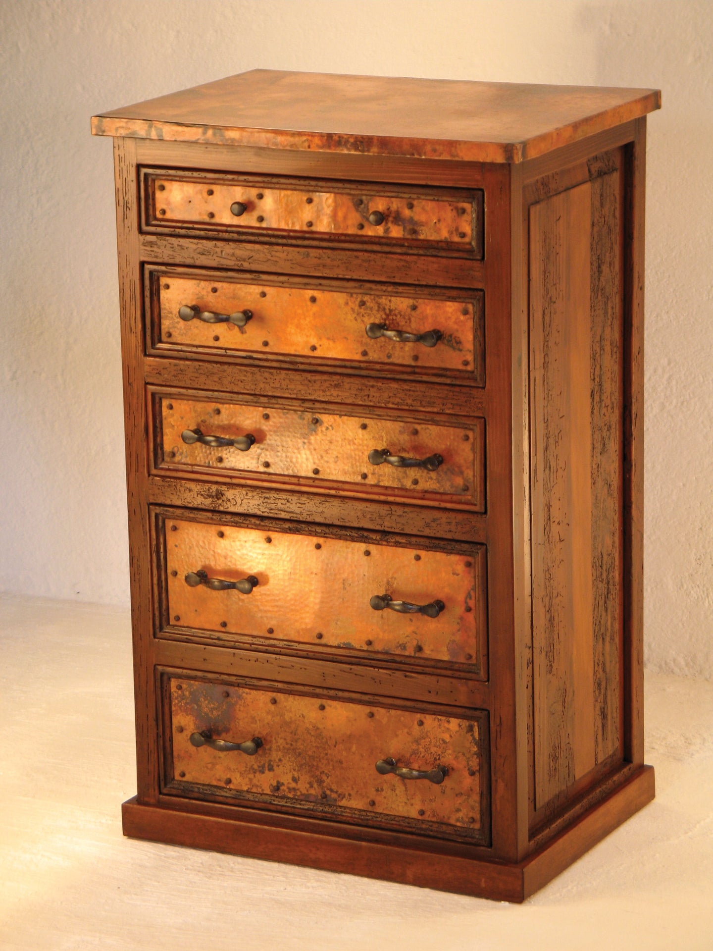 Add rustic elegance to your home with the 5-Drawer Tall Copper Dresser. Handcrafted with reclaimed wood and hammered copper for timeless beauty and lasting storage.
