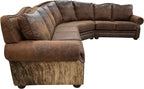 The Sandpoint Sectional features Cora Pecan leather, Floral Bone Black accents, and Hair-on-Hide Dark Exotic cowhide. With a large three-cushion pie piece and three-point yoke back cushions, this Western sectional offers luxury, comfort, and bold style.