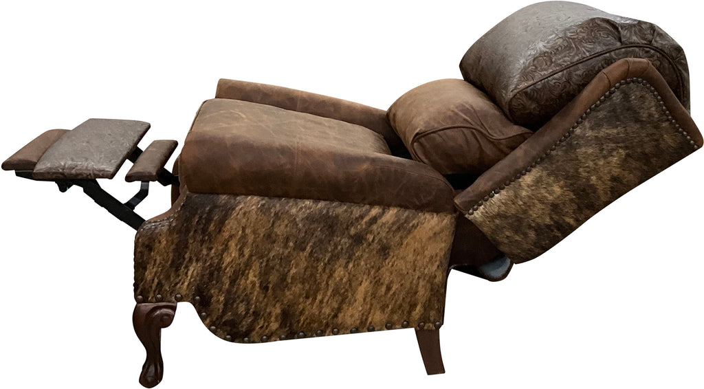 The Sandpoint Recliner combines Cora Pecan leather, Floral Bone Black embossed accents, and Hair-on-Hide Dark Exotic cowhide. A handcrafted Western-style recliner with classic wingback design, double bustleback cushions, and classic nailhead trim.