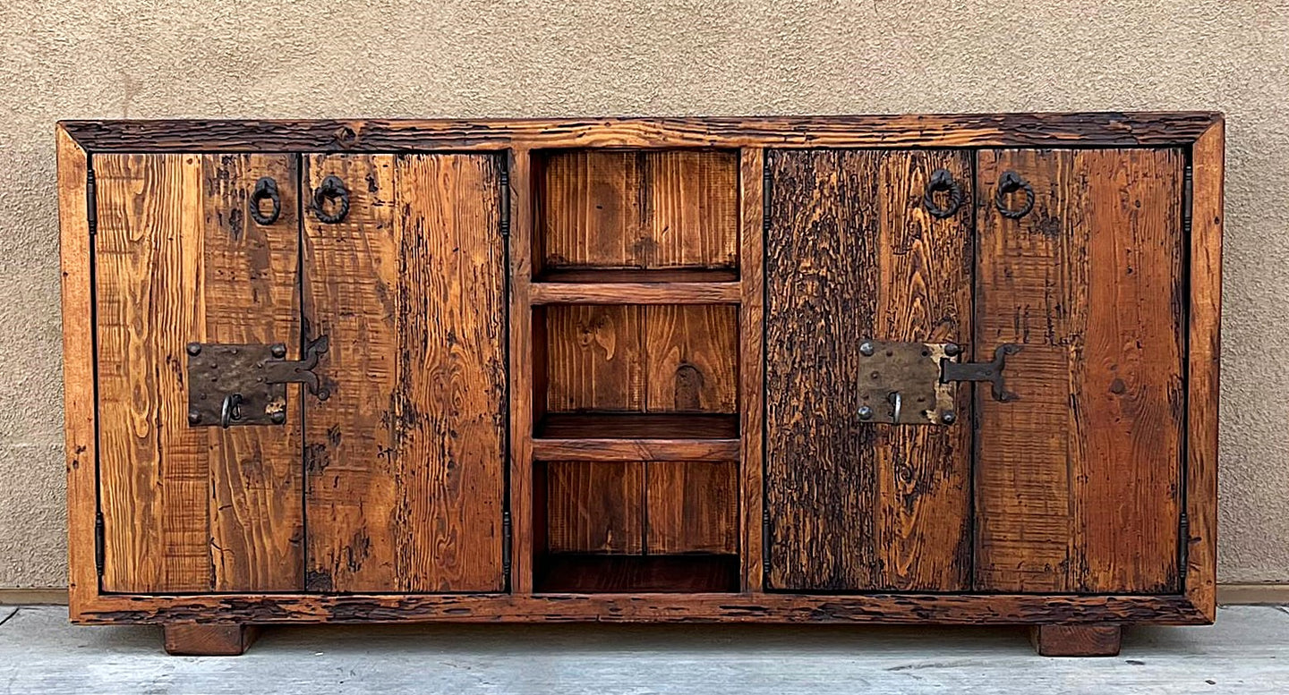 old world credenza Rustic wooden cabinet with metal handles against a beige wall.