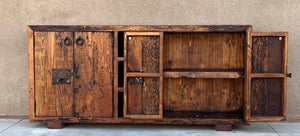 old world rustic credenza reclaimed Wooden sideboard with rustic design against a beige wall