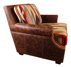 A Western Trails chair with brown Cora Pecan leather upholstery and Rustic Walnut Gator accents, featuring Wyeth Trail Pendleton-style fabric on the seat and back cushions, placed in a room with wooden walls.