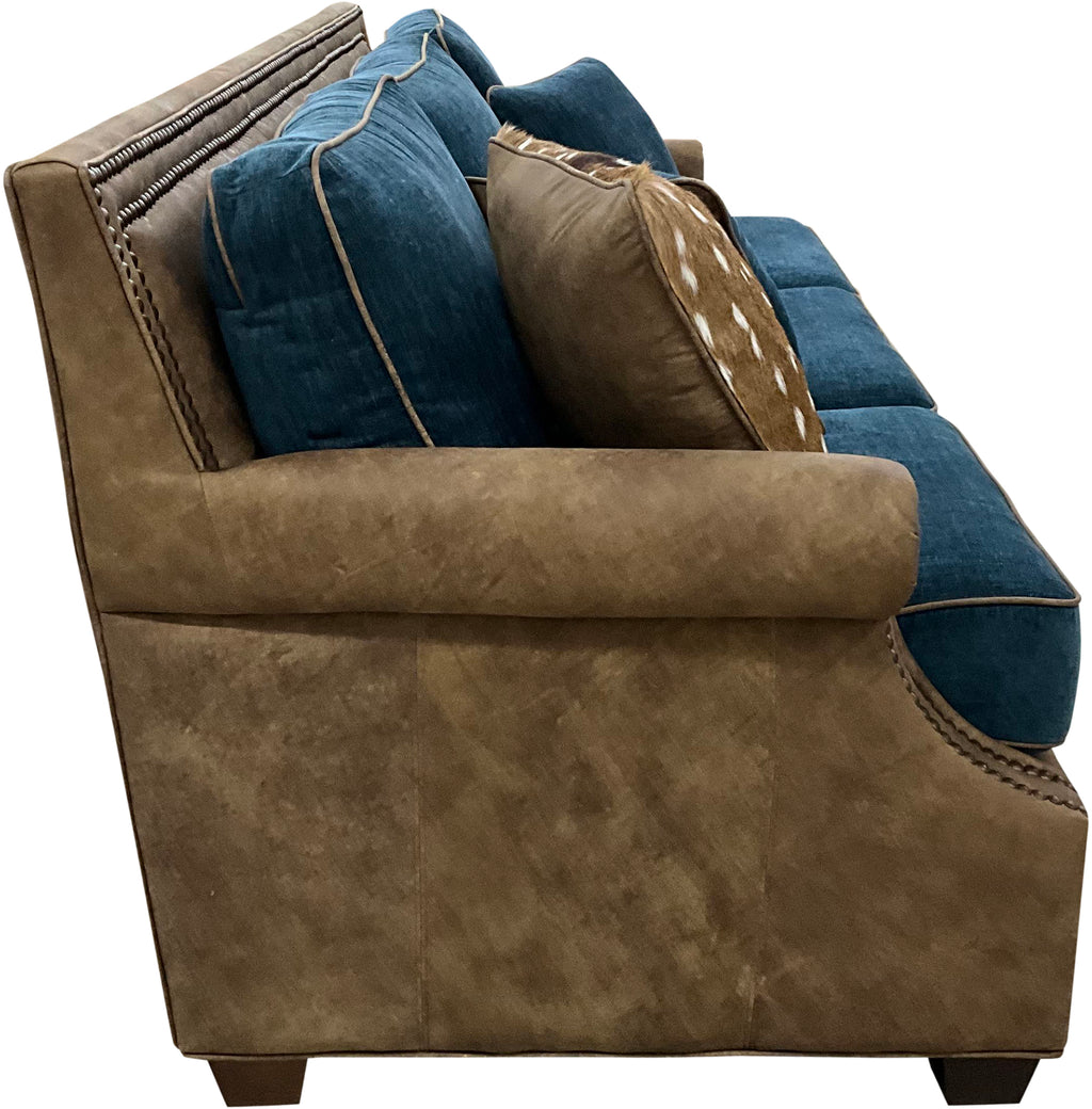 Luxury Western sofa with Stallone Branch leather frame, Devotion Denim fabric cushions, and Axis hide accents. Nailhead trim designer ranch and lodge sofa.