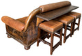 Brown leather sofa with matching armchair and stools on a white background
