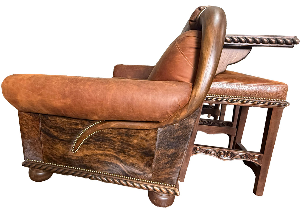 Brown leather armchair with intricate detailing on a white background