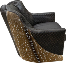 Load image into Gallery viewer, Brown leather swivel chair with quilted diamond tufted pattern and authentic axis deer hide wrapped around the outside arms