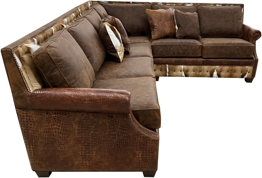 The Springbok Sylvester Sectional Sofa blends Cora Pecan leather, Springbok hides, and Gator Hornback accents in a right arm sofa + square corner + left arm loveseat design. A bold Western statement piece, customizable to fit your home.