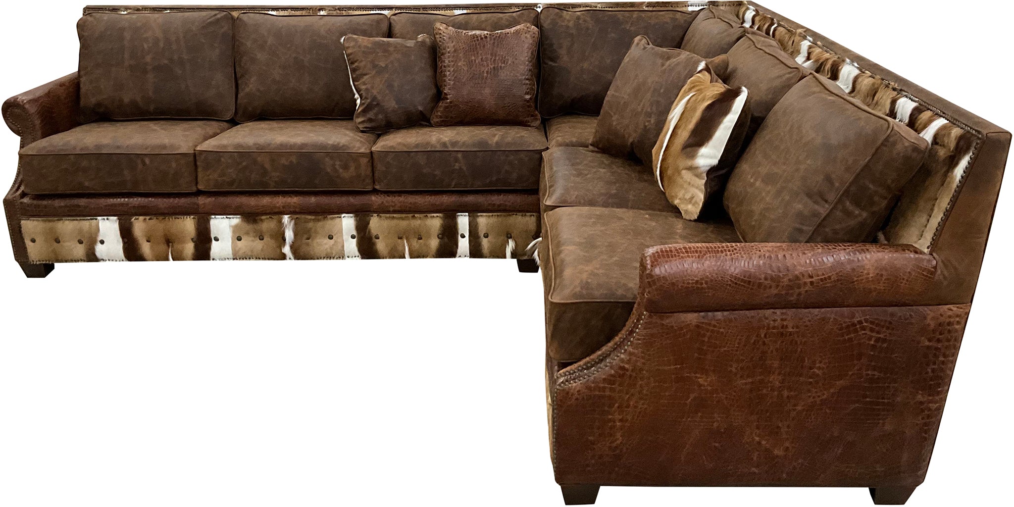 The Springbok Sylvester Sectional Sofa blends Cora Pecan leather, Springbok hides, and Gator Hornback accents in a right arm sofa + square corner + left arm loveseat design. A bold Western statement piece, customizable to fit your home.