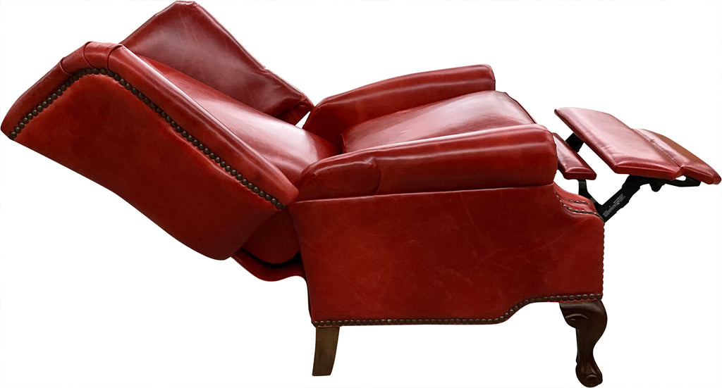 The Paloma Wingback Recliner pairs full-grain crimson leather with handcrafted wood details and a smooth reclining design. A bold expression of Western sophistication — built for beauty, comfort, and lasting craftsmanship.