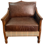 Brown leather armchair with plaid patterned base on a white background