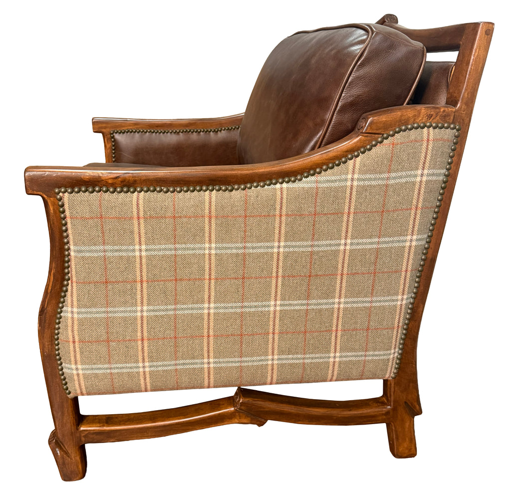 Chair with plaid fabric and wooden frame on a white background