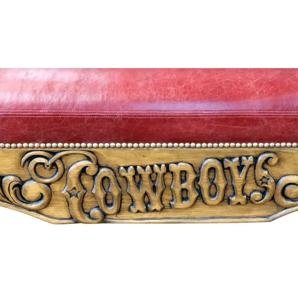 Handcrafted Western bench with longhorn carving, red leather seat, and “Cowboys” inscription. The Cowboy Bench combines rustic artistry with bold, personalized craftsmanship.