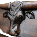 Handcrafted Western bench with longhorn carving, ranch brands, and dark finish. The Cowboy 2 Bench blends rustic strength and refined artistry in a customizable heirloom design.