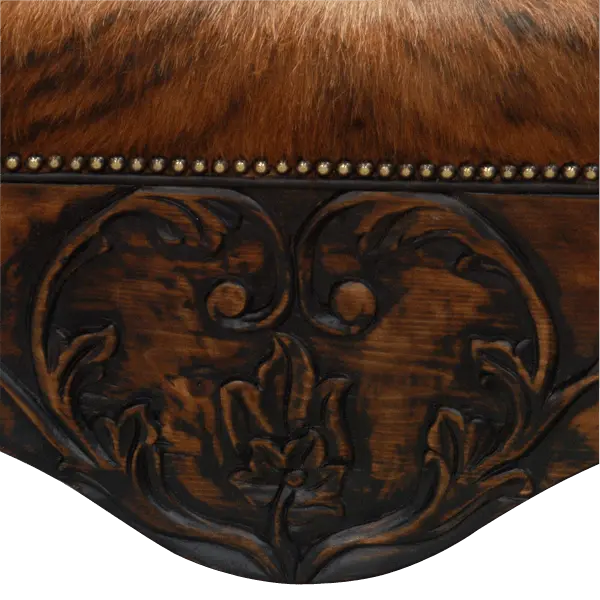 Handcrafted Western bench featuring real cowhide upholstery, carved floral apron, and cowhorn legs. The Santa Petronilla Bench embodies rustic refinement and customizable craftsmanship.