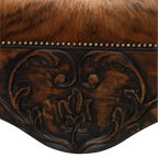 Handcrafted Western bench featuring real cowhide upholstery, carved floral apron, and cowhorn legs. The Santa Petronilla Bench embodies rustic refinement and customizable craftsmanship.