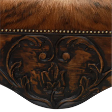 Load image into Gallery viewer, Handcrafted Western bench featuring real cowhide upholstery, carved floral apron, and cowhorn legs. The Santa Petronilla Bench embodies rustic refinement and customizable craftsmanship.