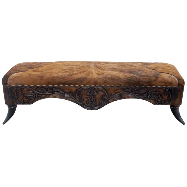 Handcrafted Western bench featuring real cowhide upholstery, carved floral apron, and cowhorn legs. The Santa Petronilla Bench embodies rustic refinement and customizable craftsmanship.