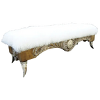 Handcrafted Western bench with Tibetan wool upholstery, silver-finished carvings, and copper conchos. The Santa Petronilla II Bench blends rustic elegance and artisanal craftsmanship in a truly unique design.