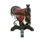 The Bronco Saddle Barstool features a handcrafted full-grain leather saddle seat with cowhide fenders, hand-forged iron medallion, and wood pedestal base. A 180° swivel Western barstool blending authentic cowboy craftsmanship with rustic luxury.