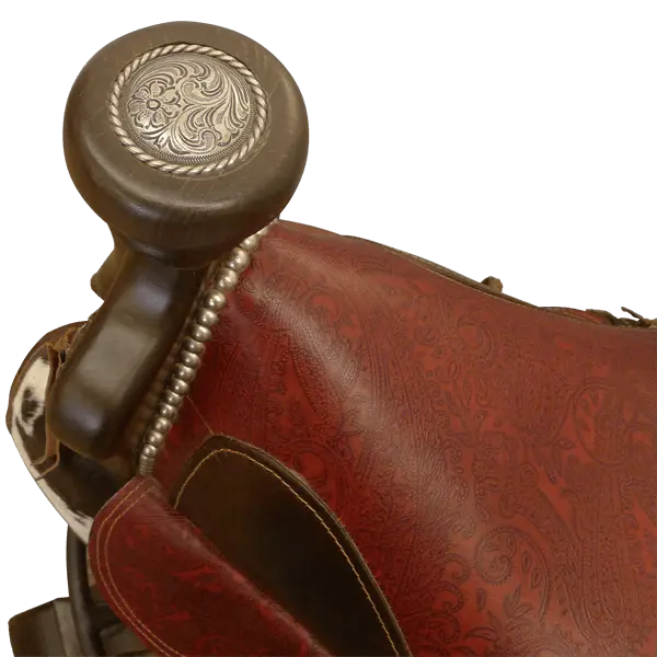 The Bronco Saddle Barstool features a handcrafted full-grain leather saddle seat with cowhide fenders, hand-forged iron medallion, and wood pedestal base. A 180° swivel Western barstool blending authentic cowboy craftsmanship with rustic luxury.