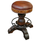 The El Matador Bajo 5 Barstool features brown full-grain leather, hand-tooled accents, and a carved wood base with a forged iron footrest. A 360° swivel and customizable design make it a perfect blend of comfort and craftsmanship.