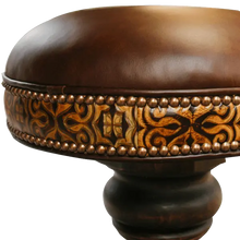 Load image into Gallery viewer, The El Matador Bajo 5 Barstool features brown full-grain leather, hand-tooled accents, and a carved wood base with a forged iron footrest. A 360° swivel and customizable design make it a perfect blend of comfort and craftsmanship.