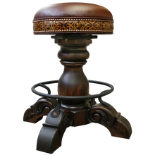 Load image into Gallery viewer, The El Matador Bajo 5 Barstool features brown full-grain leather, hand-tooled accents, and a carved wood base with a forged iron footrest. A 360° swivel and customizable design make it a perfect blend of comfort and craftsmanship.