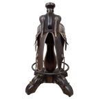 The Chaps Saddle Barstool features full-grain leather, embossed Western patterns, copper conchos, and a 180° swivel wooden base. A handcrafted Western saddle barstool that celebrates cowboy craftsmanship and the artistry of the American frontier.