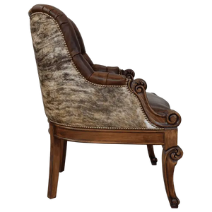 The La Antigua 6 Chair features hand-carved scroll details, tufted full-grain leather, and a sturdy wood frame. Precision hand-tacked upholstery and customizable finishes define this handcrafted Western-style accent chair.