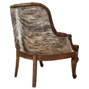 The La Antigua 6 Chair features hand-carved scroll details, tufted full-grain leather, and a sturdy wood frame. Precision hand-tacked upholstery and customizable finishes define this handcrafted Western-style accent chair.