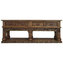 Load image into Gallery viewer, Handcrafted Spanish colonial console with baroque floral scroll carvings, forged iron handles, 4 drawers, platform base &amp; antique finish. Customize your luxury Western décor piece.