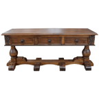 Handcrafted Spanish colonial console with carved scrollwork, twist rope details, forged iron pulls, turned pedestals, and customizable solid wood construction.