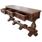Handcrafted Spanish colonial console with carved scrollwork, twist rope details, forged iron pulls, turned pedestals, and customizable solid wood construction.