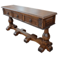 Handcrafted Spanish colonial console with carved scrollwork, twist rope details, forged iron pulls, turned pedestals, and customizable solid wood construction.