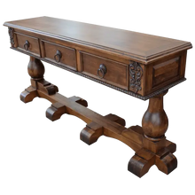 Load image into Gallery viewer, Handcrafted Spanish colonial console with carved scrollwork, twist rope details, forged iron pulls, turned pedestals, and customizable solid wood construction.