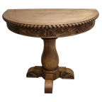 Handcrafted half-round table with carved floral apron, twist-rope edge, and pedestal base. The San Felipe Half-Round Table blends elegance, versatility, and artisan woodworking.