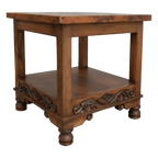 Handcrafted end table with hand-hammered copper top, floral carvings, and bun feet. The DuPont End Table blends Western character with timeless, artisanal craftsmanship.